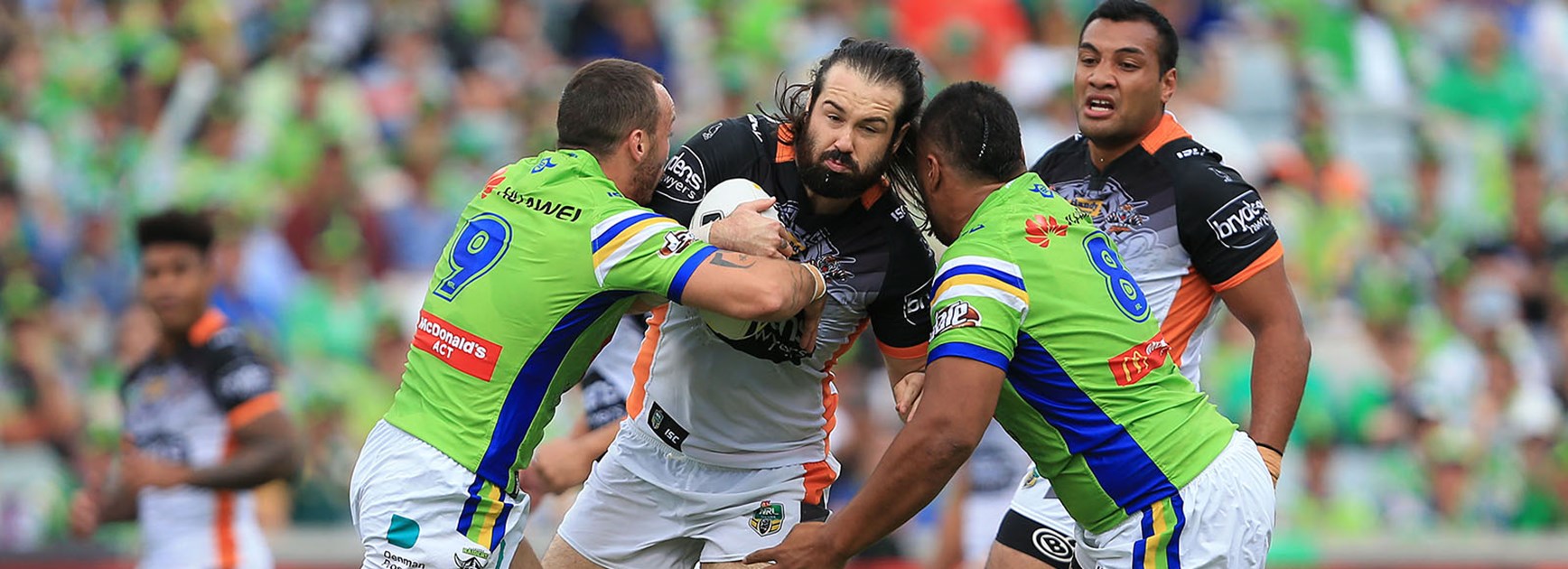Aaron Woods battles in a tackle against the Raiders in Round 3.