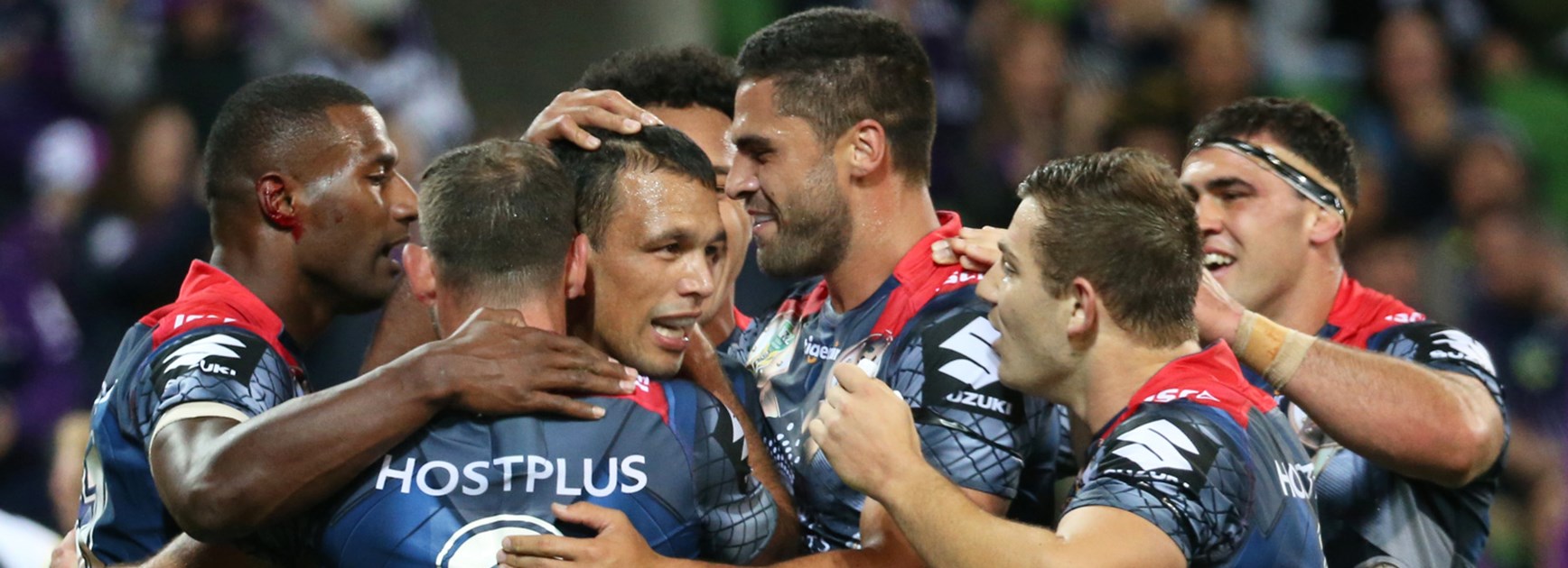 The Storm celebrate a first-half try against the Panthers on Saturday night.