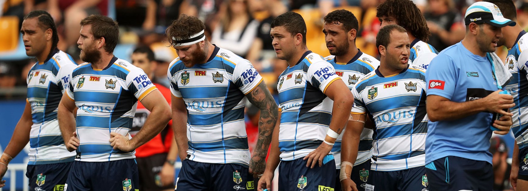 Titans players look on dejected during their loss to the Warriors.