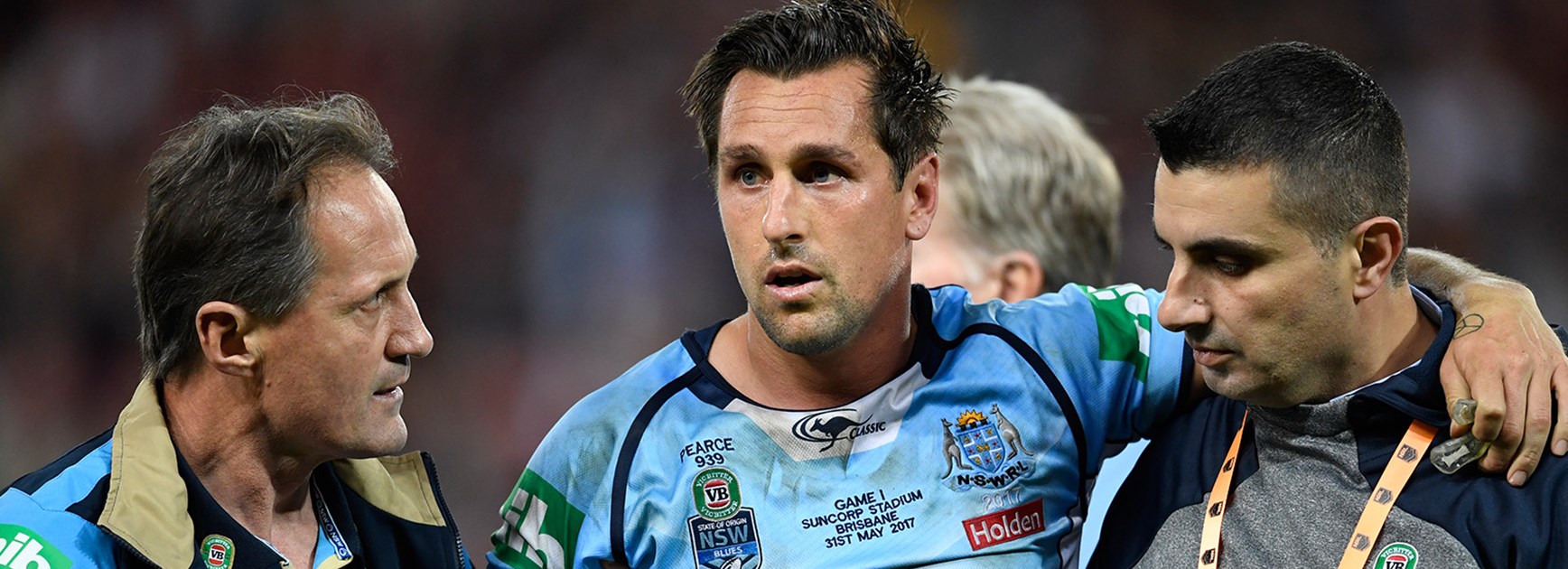 Mitchell Pearce leaves the field after copping a heavy knock in Origin I.