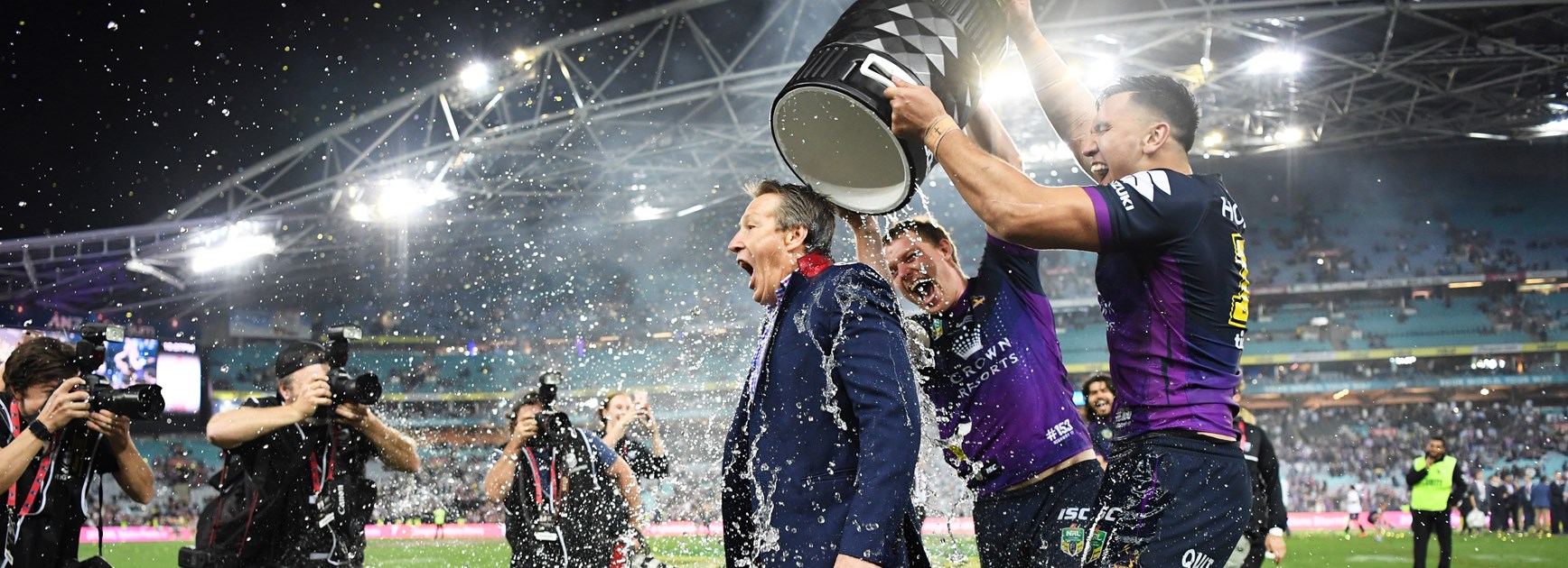 Craig Bellamy cops a shower after Melbourne's 2017 NRL Grand Final win.