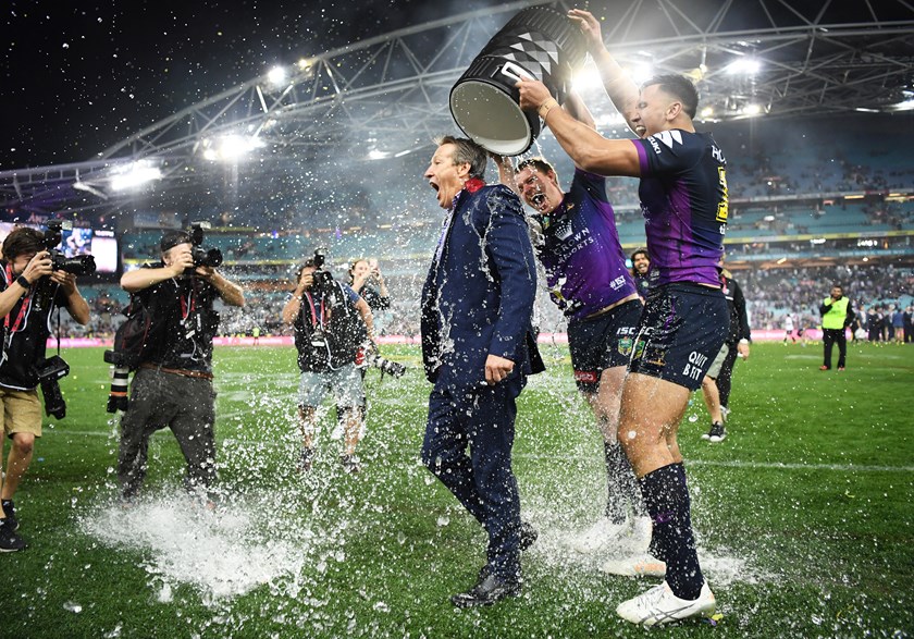 Craig Bellamy cops a shower after Melbourne's 2017 NRL Grand Final win.