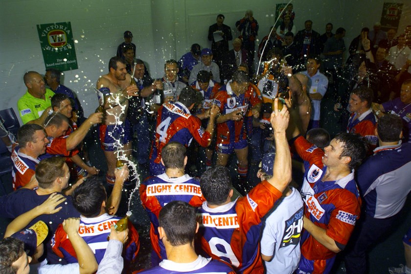 Knights players celebrate their 2001 grand final win.