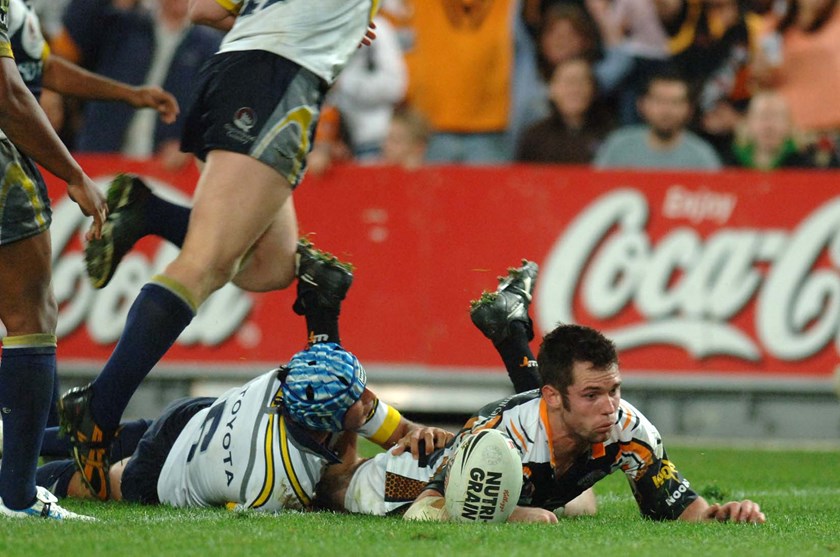 Wests Tigers winger Pat Richards scores a try against the Cowboys at ANZ Stadium.