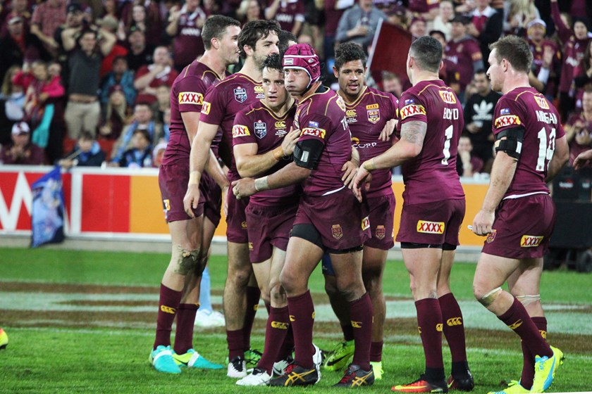 Former Maroons teammates Cooper Cronk and Johnathan Thurston share one of many happy moments in the Origin arena.
