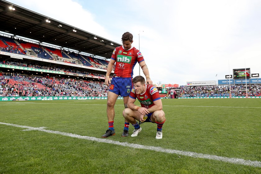 Aidan Guerra comforts teammate Lachlan Fitzgibbon after being thrashed by the Sharks.