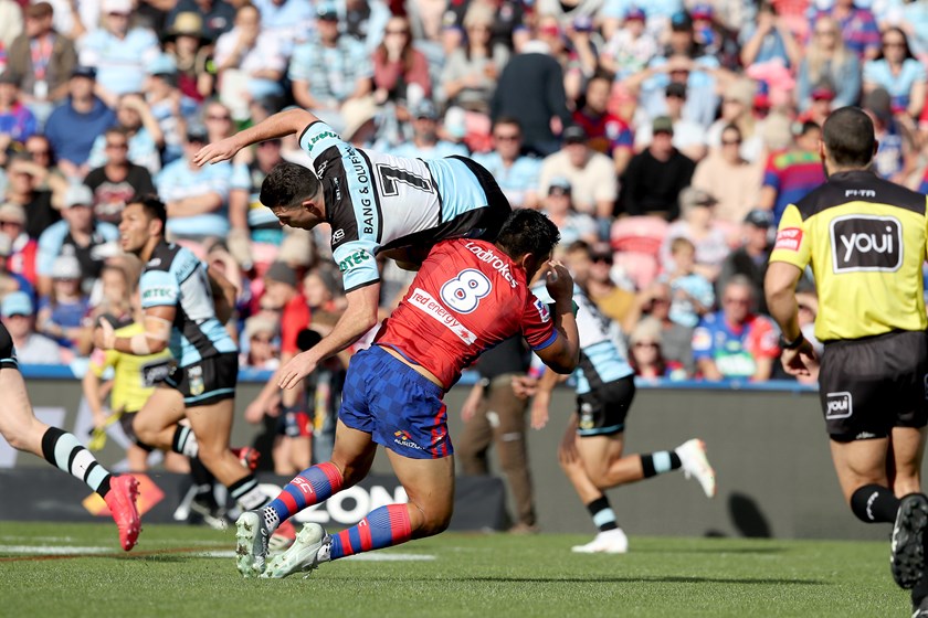 Sharks halfback Chad Townsend is upended.