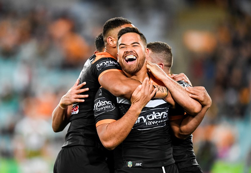 Esan Marsters celebrates a try for Wests Tigers.