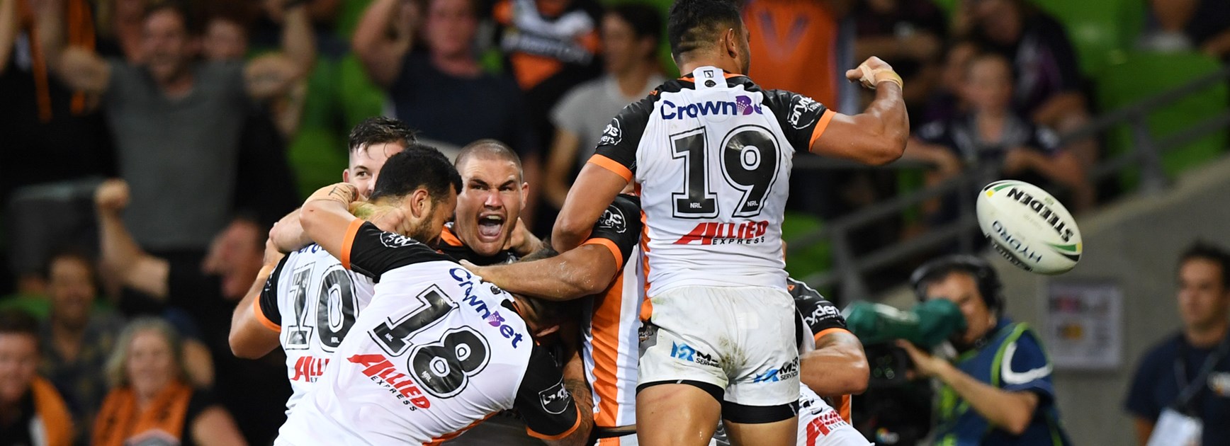 Tigers players celebrate wildly after beating the Storm.