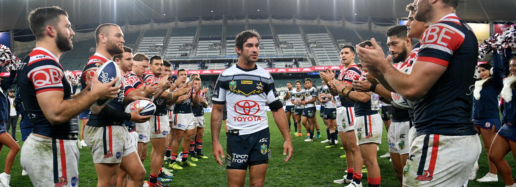 Cowboys champion Johnathan Thurston receives a guard of honour from the Roosters.