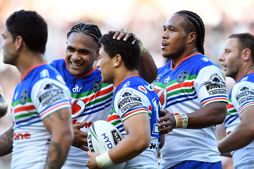 Warriors players celebrate a try versus the Roosters.