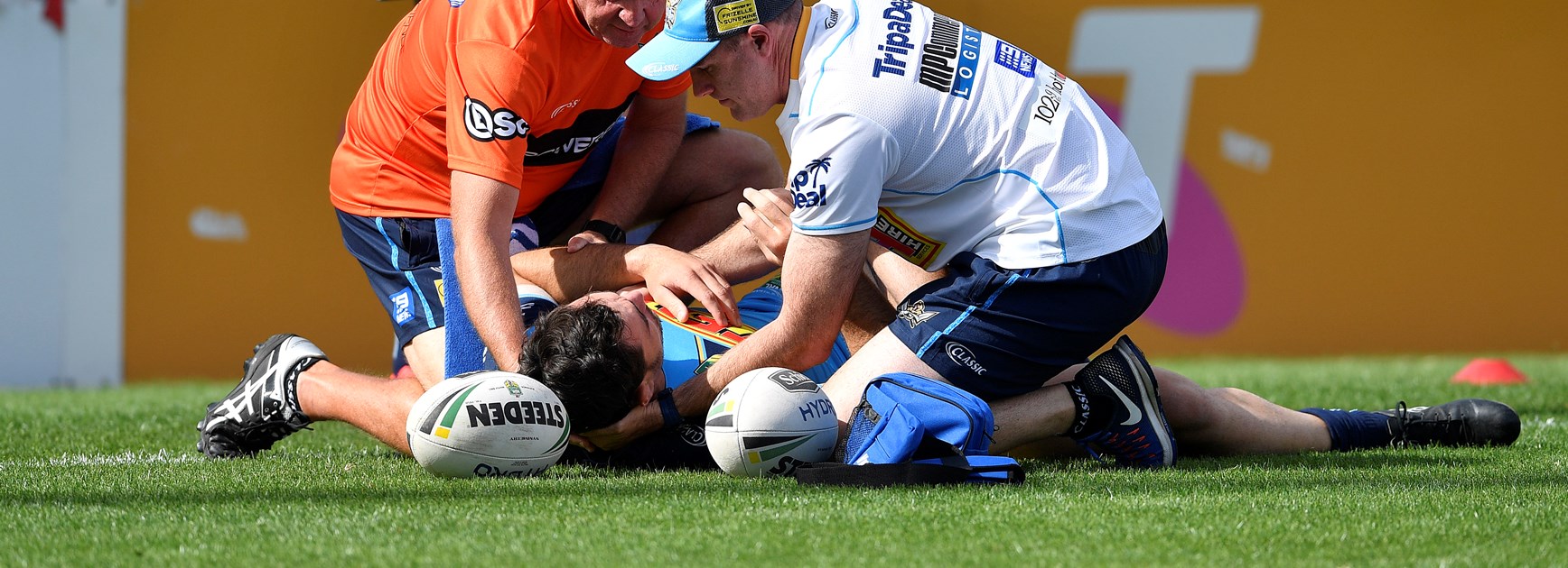 Titans forward Morgan Boyle receives treatment after a head clash with teammate Bryce Cartwright.