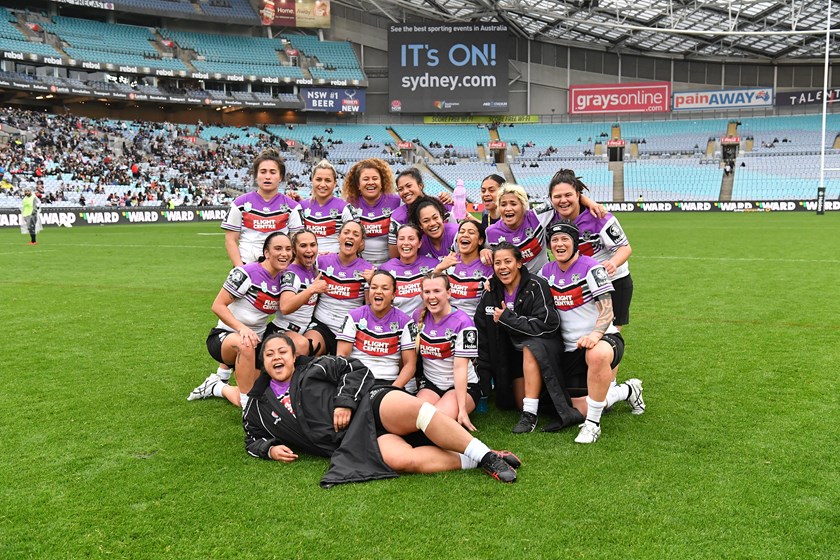 The Warriors women's team celebrate beating the Roosters.