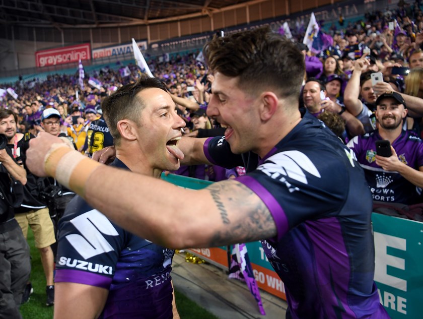 Curtis Scott celebrates the 2017 grand final win with Cooper Cronk.
