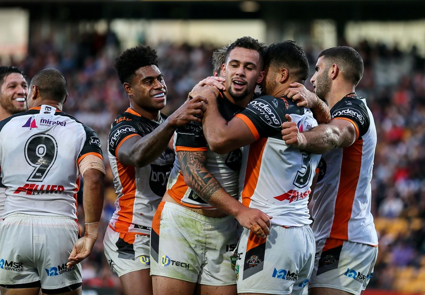 Tigers forward Josh Aloiai is congratulated after scoring against the Storm.