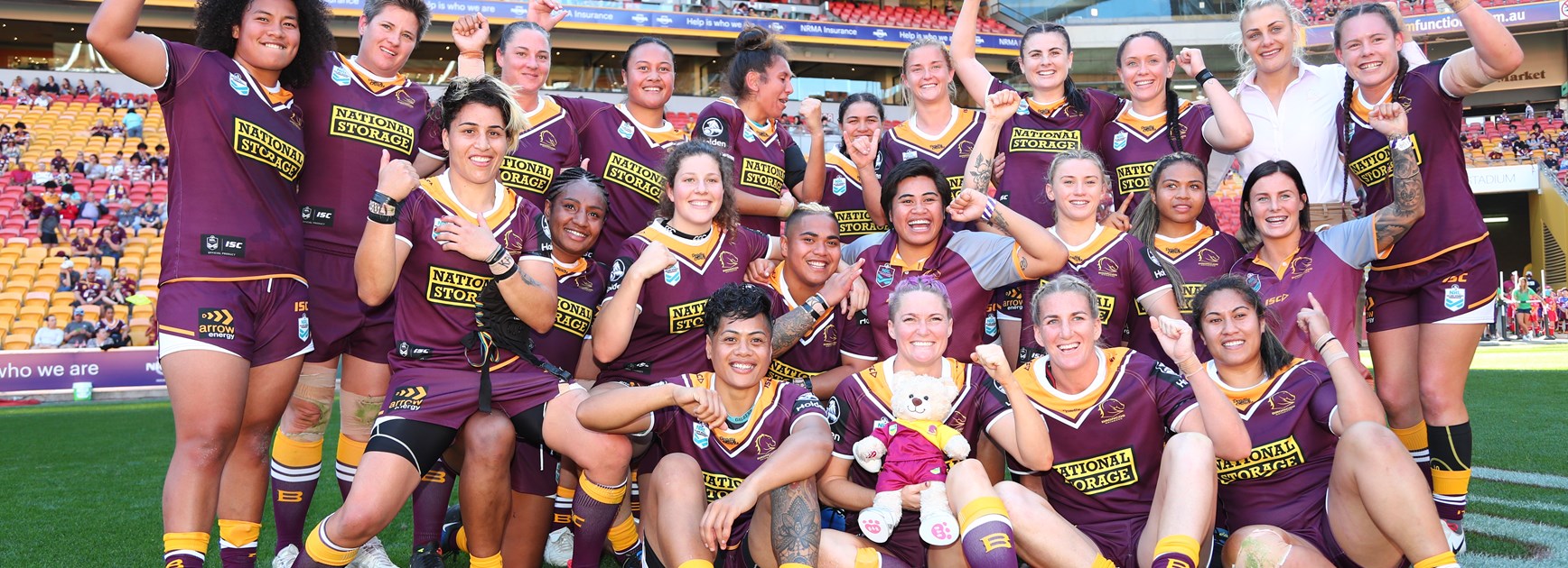 The Broncos women's team celebrate their trial win over PNG.