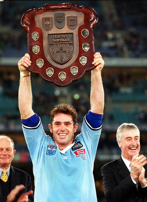 Brad Fittler holds the shield aloft after NSW won the 2000 series.