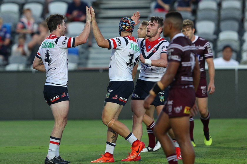 The Roosters celebrate a try against Manly.