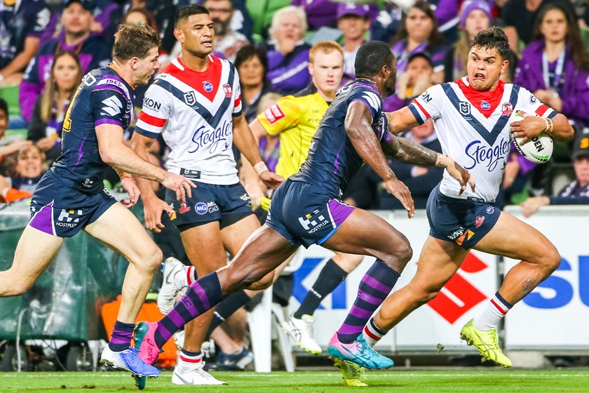 Latrell Mitchell takes on the Storm defence.