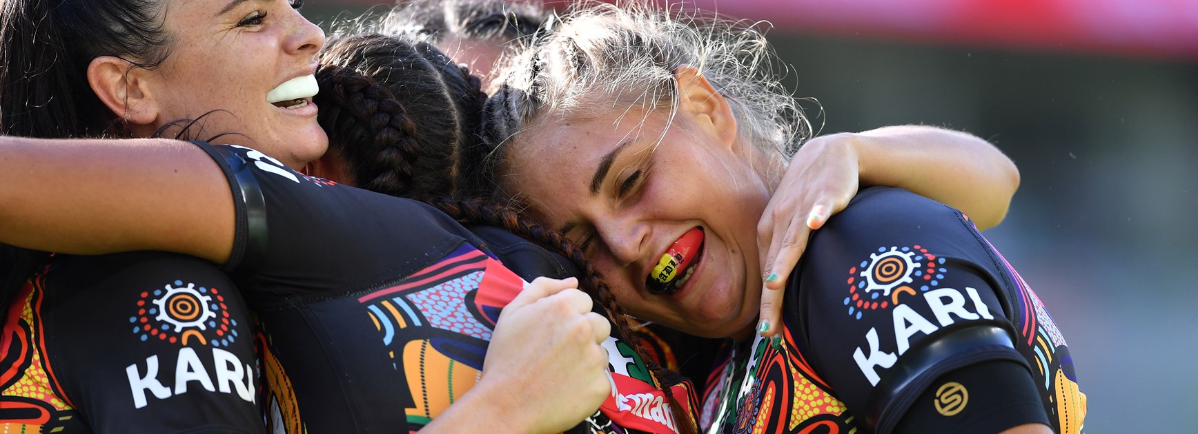 Indigenous All Stars players celebrate a try.