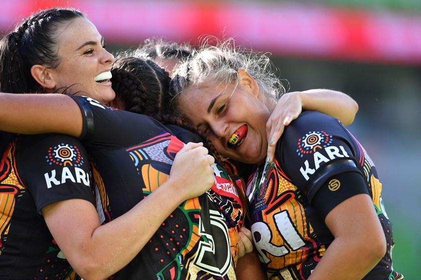 Indigenous All Stars players celebrate a try.