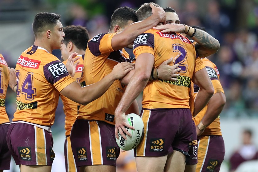 Broncos winger Corey Oates celebrates with teammates after his try against Melbourne.