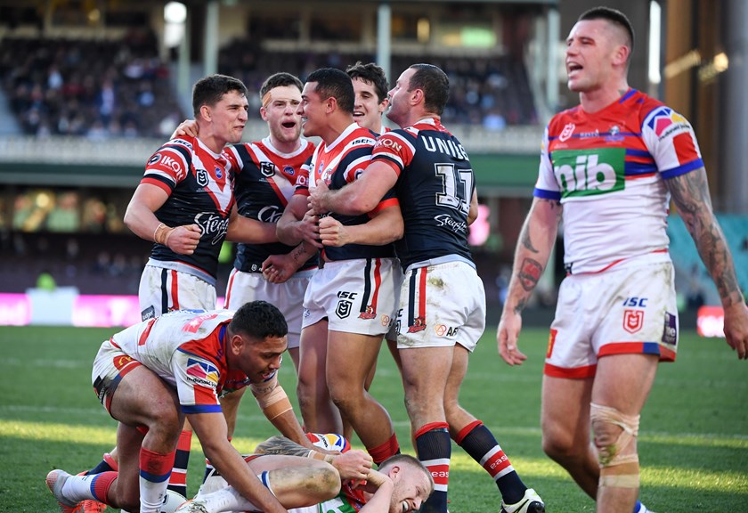 The Sydney Roosters celebrate as Shaun Kenny-Dowell suffers.