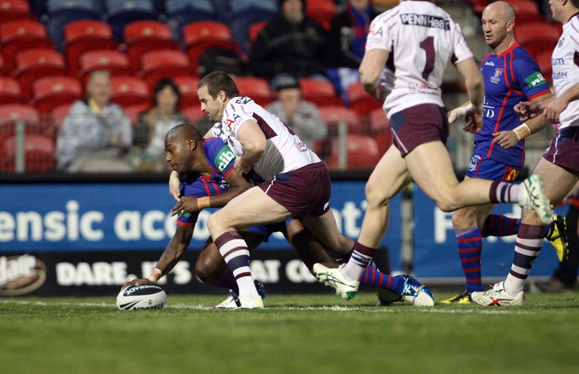 Former Knights winger Akuila Uate scores one of his three tries against Manly in 2010.