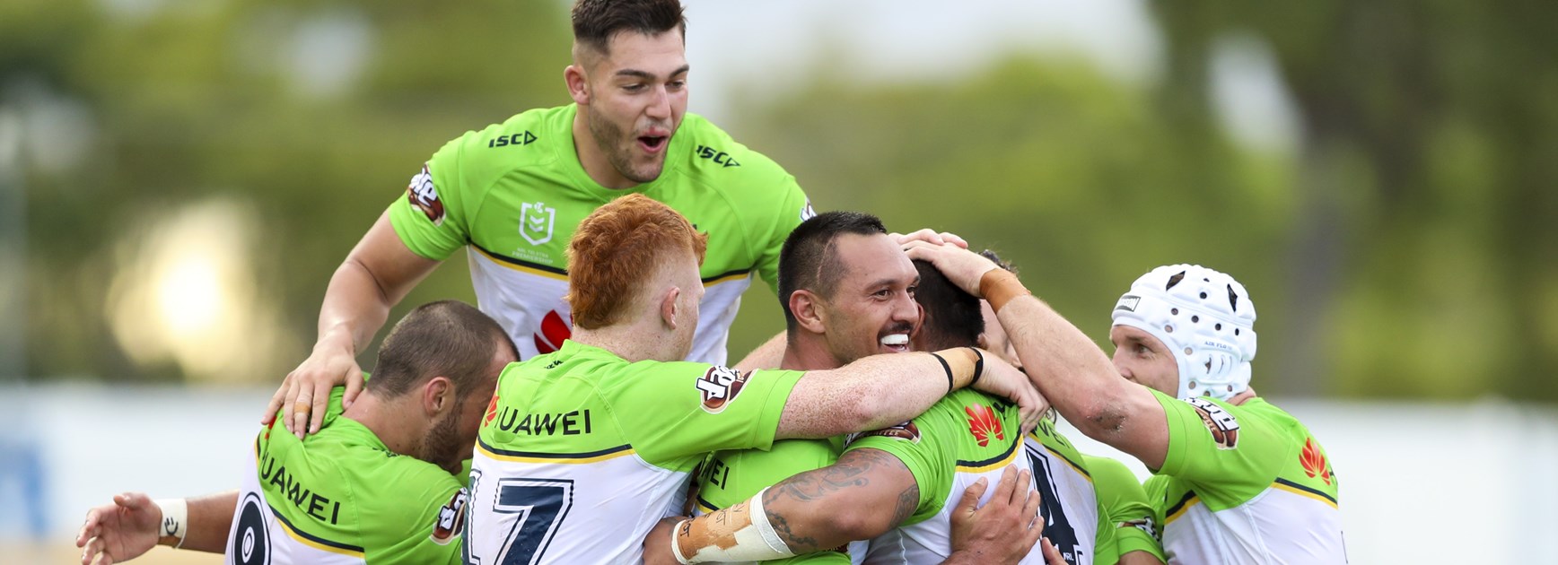 Raiders players celebrate a win over the Cowboys in Townsville 