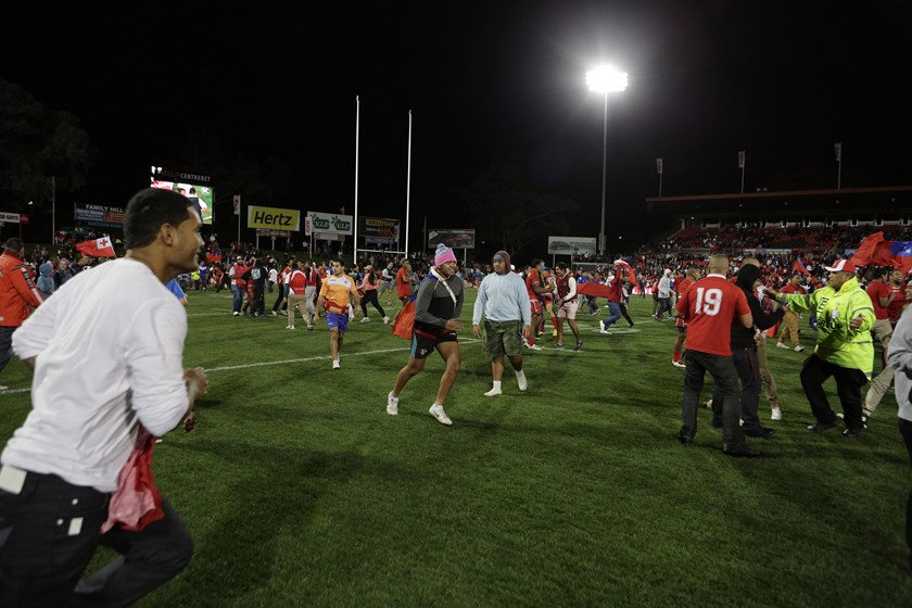 Tonga fans swarm the field late in the 2013 win against Samoa.