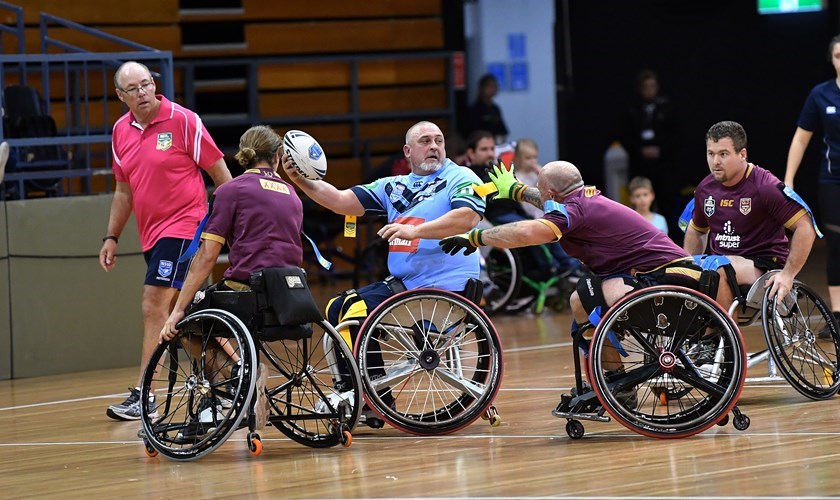 Action from the 2018  Wheelchair Rugby League match between NSW and Queensland.
