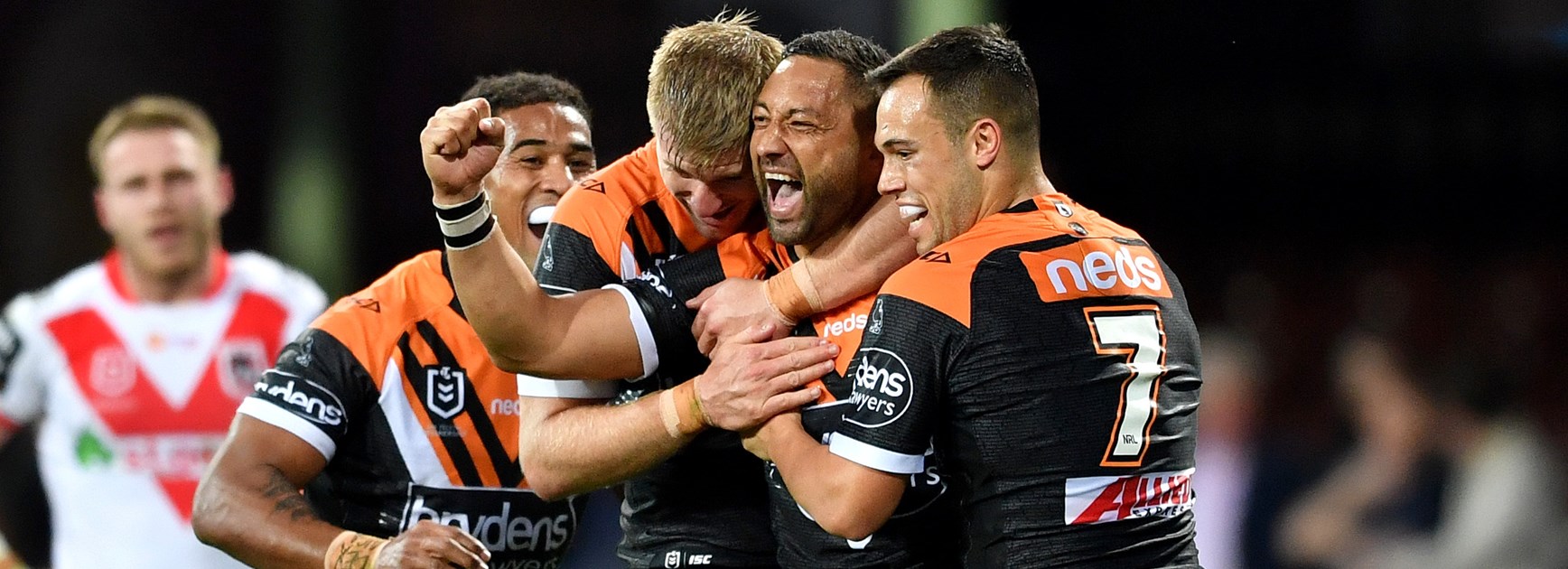 Wests Tigers celebrate a try against the Dragons.