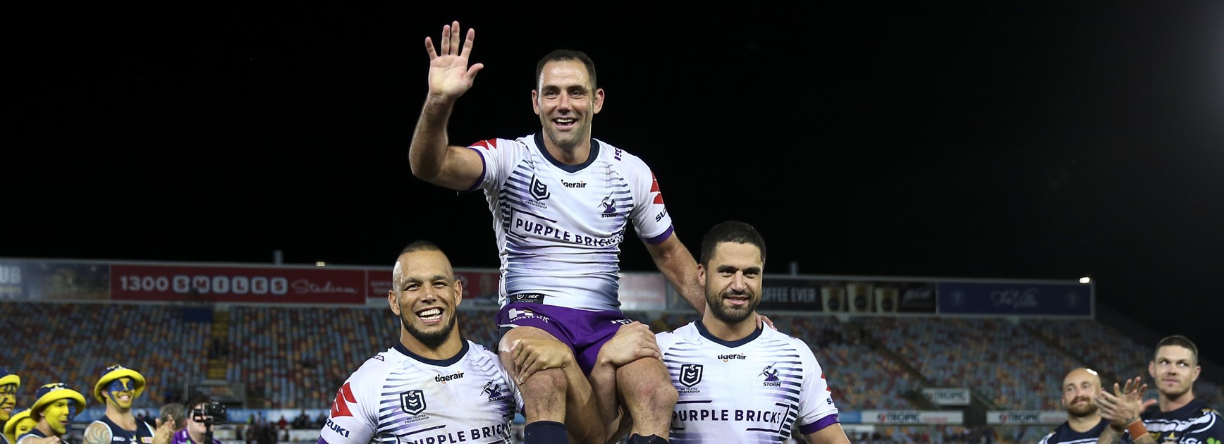 Cameron Smith is chaired off by Will Chambers and Jesse Bromwich.