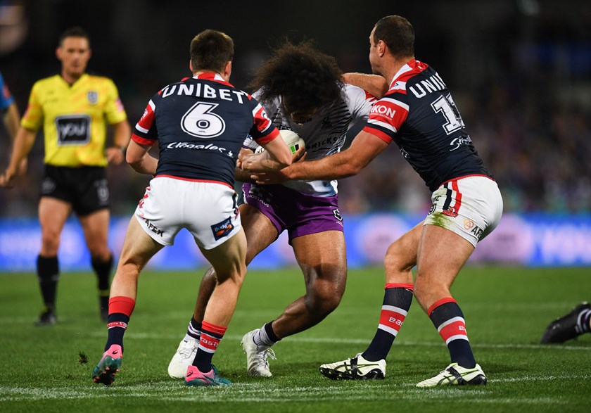 Roosters five-eighth Luke Keary tangles with Storm back-rower Felise Kaufusi.