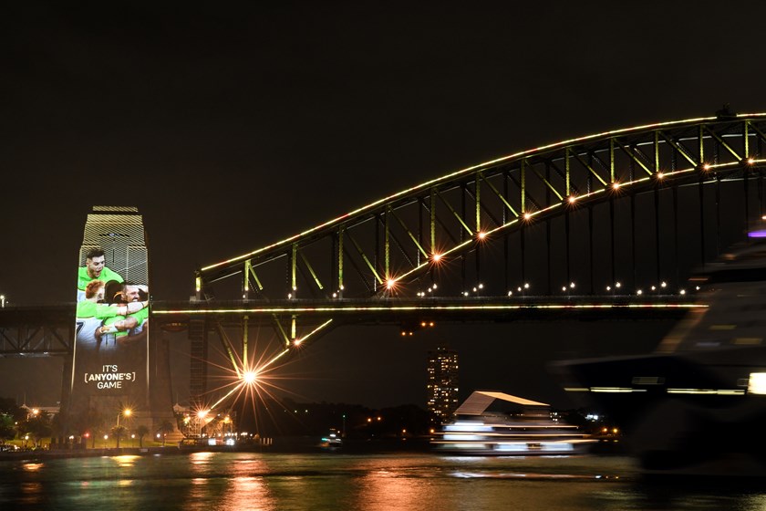 Sydney Harbour Bridge is lit up with Raiders images on Monday night.