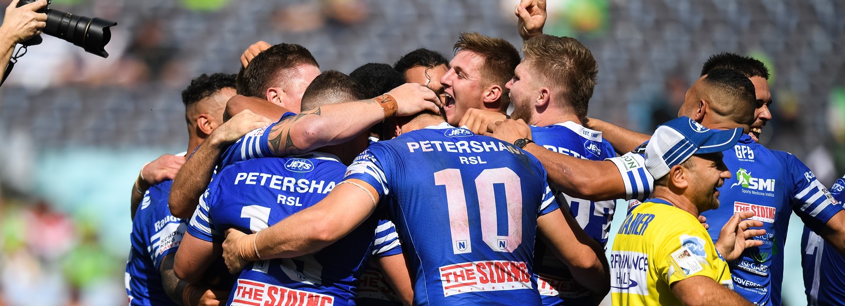 Newtown Jets players celebrate their win at ANZ Stadium.