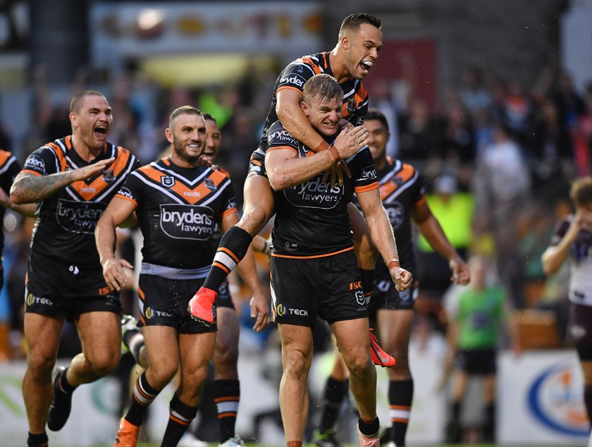 The Wests Tigers celebrate a try.