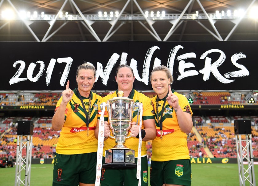 Steph Hancock celebrates the Jillaroos' 2017 World Cup triumph with Ruan Sims and Renae Kunst.