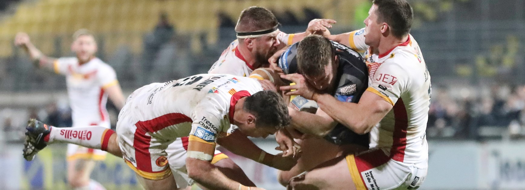 The Catalans defence swarms against Castleford.