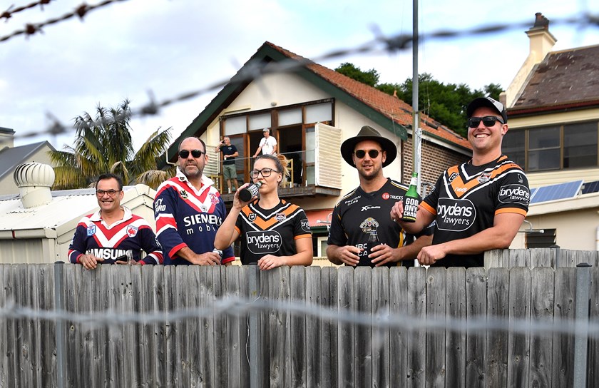 Roosters and Wests Tigers fans peer over the fence at Leichhardt Oval in round two.