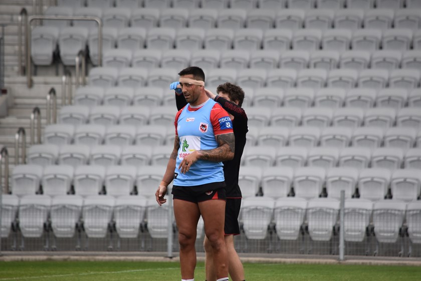 Paul Vaughan receives treatment for his head wound at training.