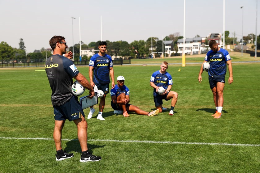 Andrew Johns passes on tips to Dylan Brown and Eels teammates at training.