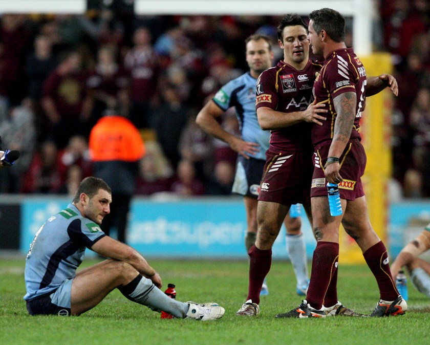 NSW hooker Robbie Farah feels the sting of defeat as the Maroons celebrate.