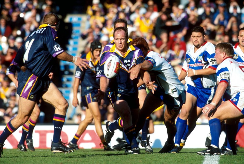 Russell Bawden gets an offload away for Melbourne in 2000.