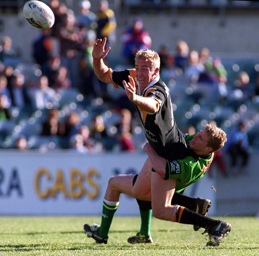 Trent Robinson offloads during his brief NRL career at the Wests Tigers in 2001.