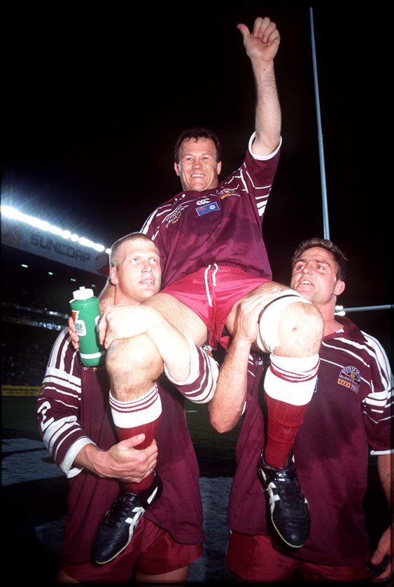 Trevor Gillmeister is chaired off by Gary Larson and Billy Moore.