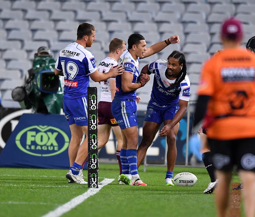 Jayden Okunbor is congratulated after scoring a try against Manly.