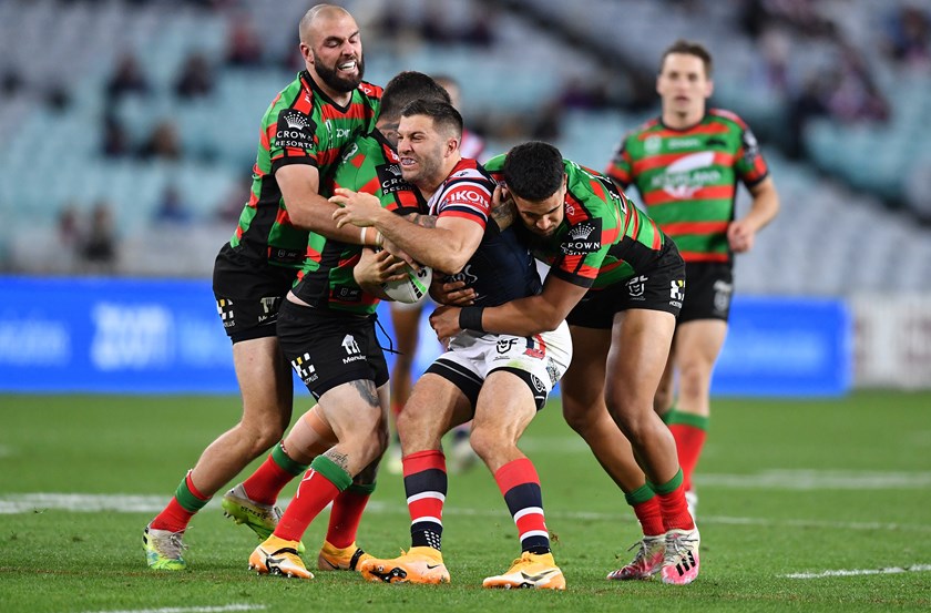 South Sydney's defence wraps up Roosters star James Tedesco.