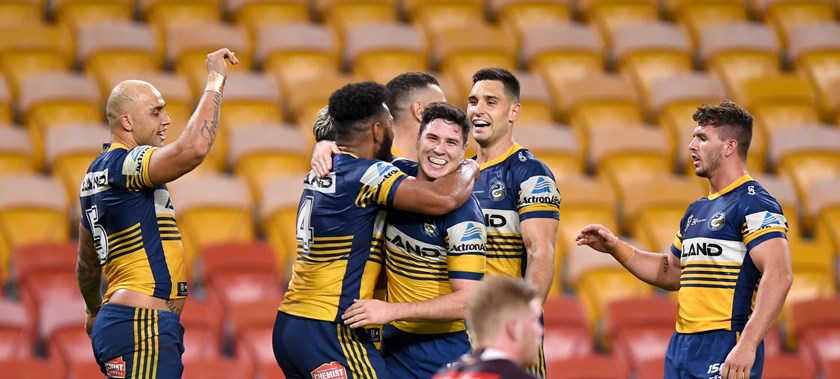 Eels players celebrate a try against Brisbane in front of empty stands in round 3, 2020.