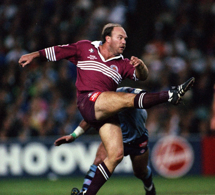 The King, Wally Lewis kicks the ball downfield.